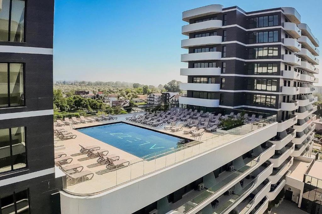 an aerial view of a building with a swimming pool at Zyra Blue Heart Pool & Spa in Năvodari