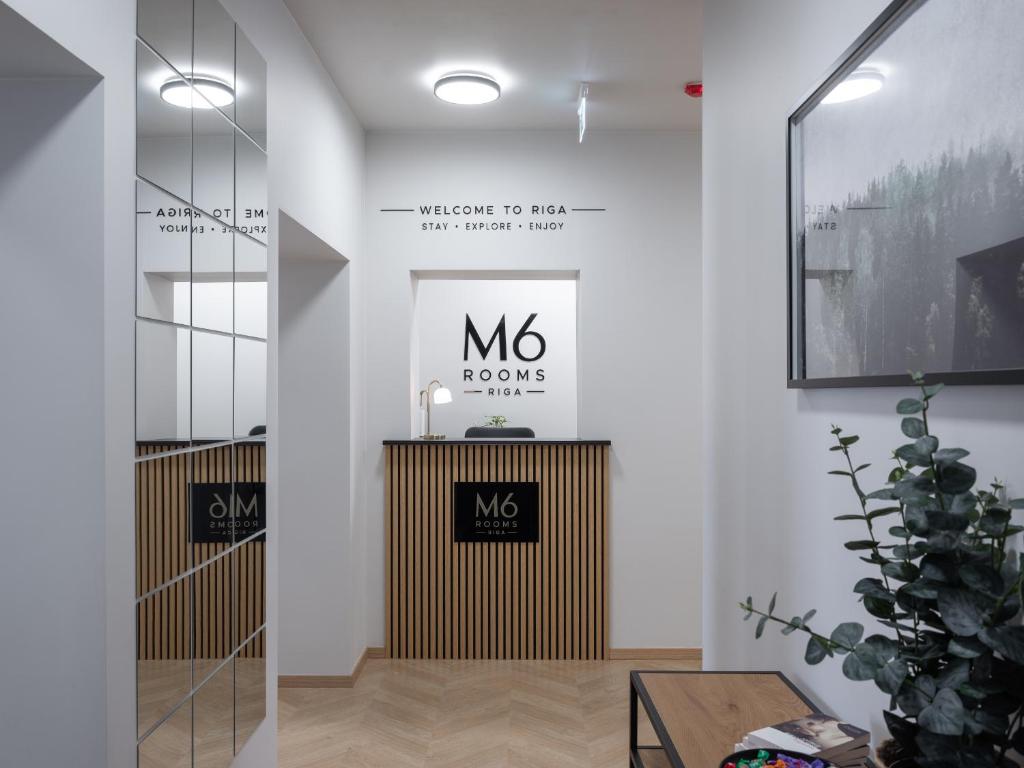 a lobby with a mox house sign on the wall at M6 Rooms Riga in Riga