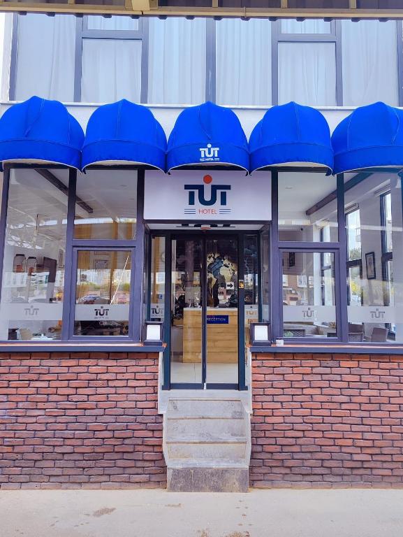a store front with blue umbrellas over the door at Tut Hotel in Antalya
