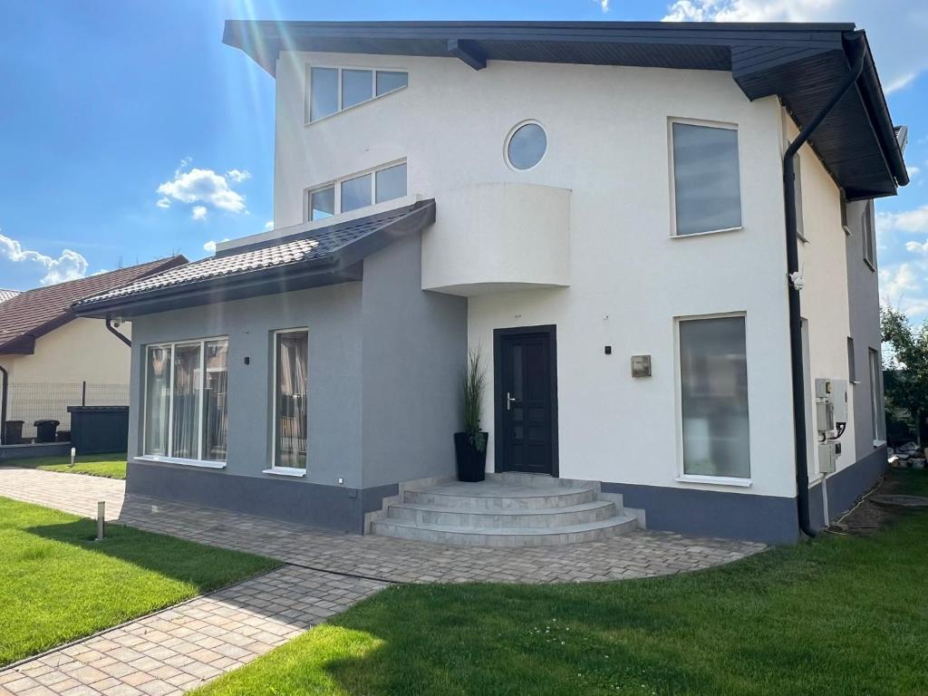 a white house with a front yard at StGeorge Retreat in Sângeorgiu de Mureș