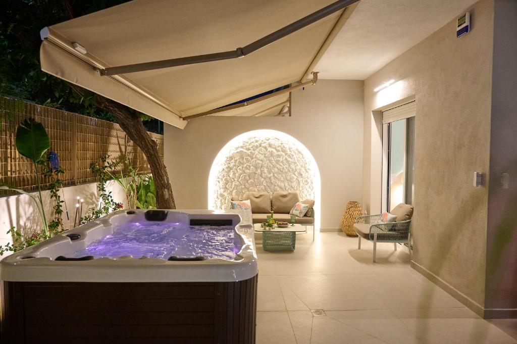 a jacuzzi tub in the middle of a living room at Perea Fiore Suites in Perea