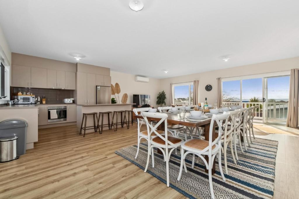 a kitchen and dining room with a table and chairs at San Remo Bay Views Phillip Island Gateway in San Remo