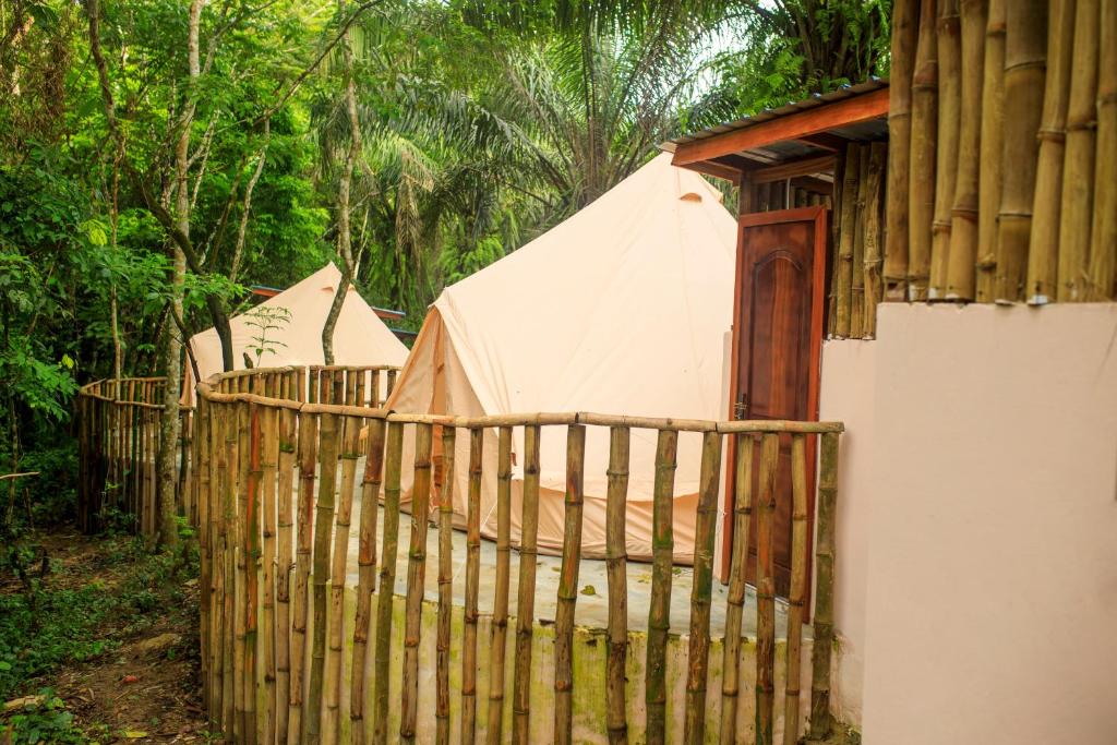a fence next to a building with a tent at Barreo Nova Eco Resort in Abrafo