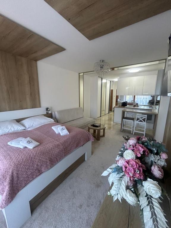 a bedroom with a bed with flowers on it at Apartio Bella in Vysoké Tatry