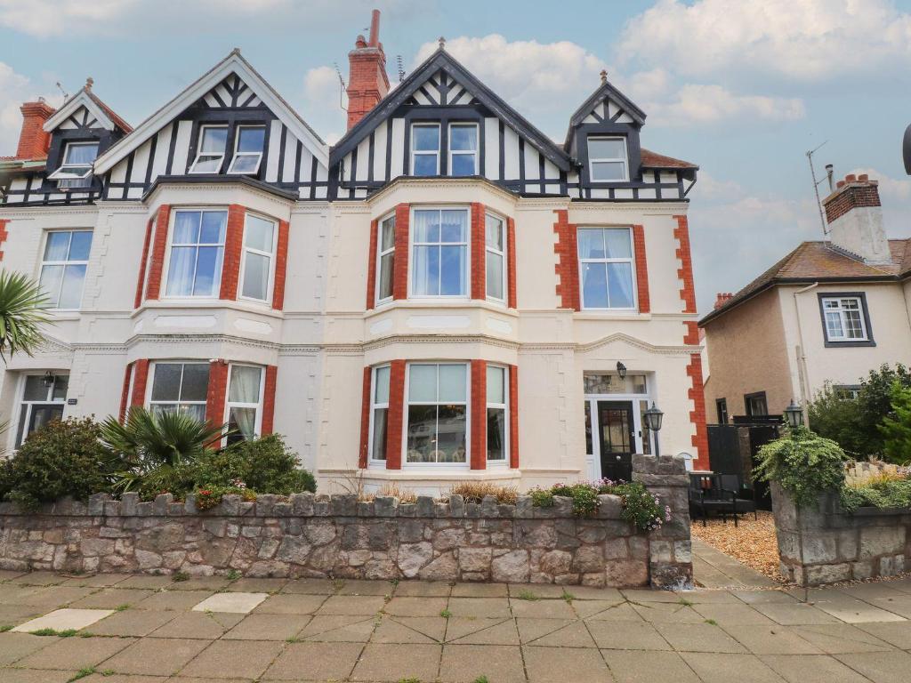 a large house with red and white windows at The Causeway in Llandudno