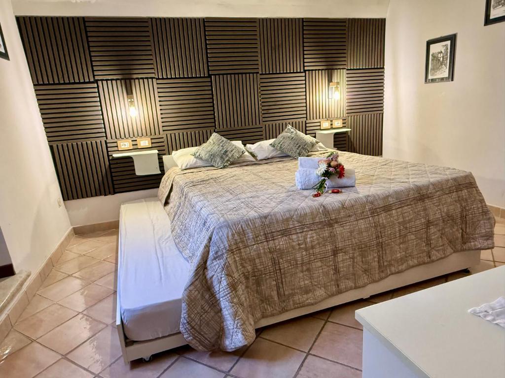a bedroom with a large bed with flowers on it at Casa Paulina in Scanno