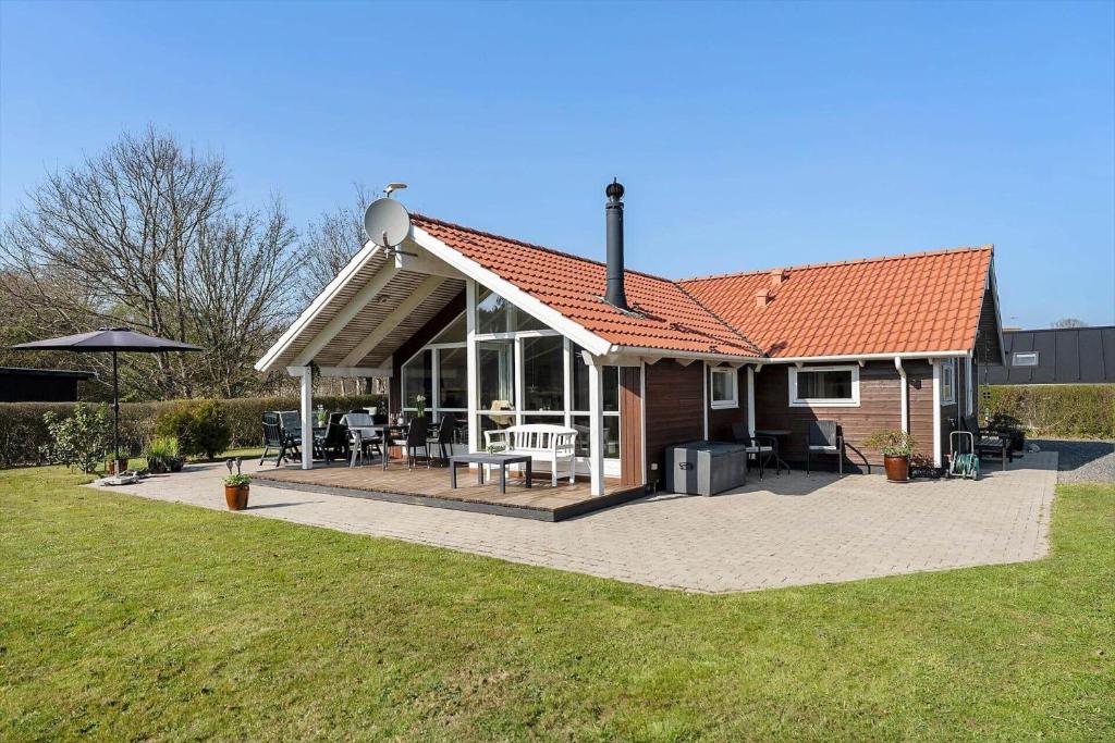 a small house with a deck and a patio at SJ285-Bjert-Kystvej-64-A in Åbjerg
