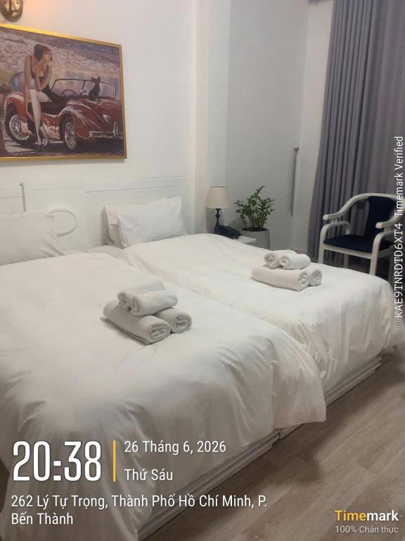 a bedroom with a bed with towels on it at Financeer Hotel in Ho Chi Minh City