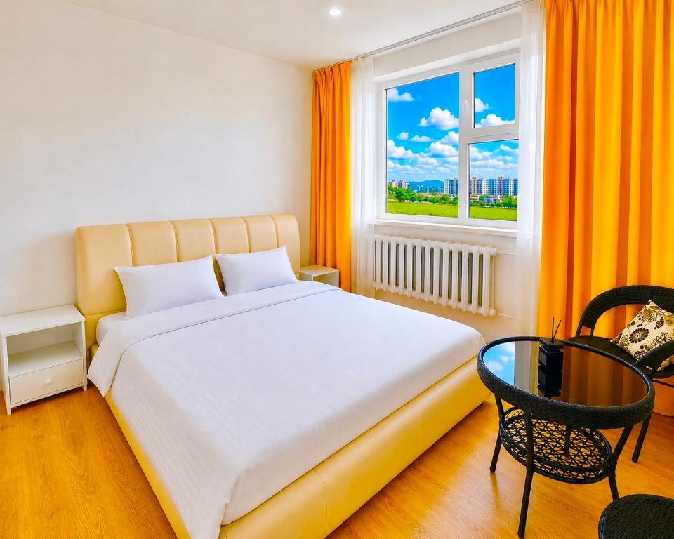 a bedroom with a large bed and a window at Yura Hostel in Darhan