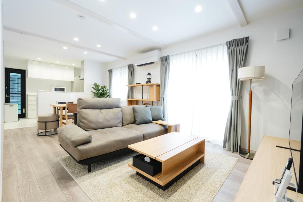 a living room with a couch and a table at Crescout Toa 1 in Gotemba