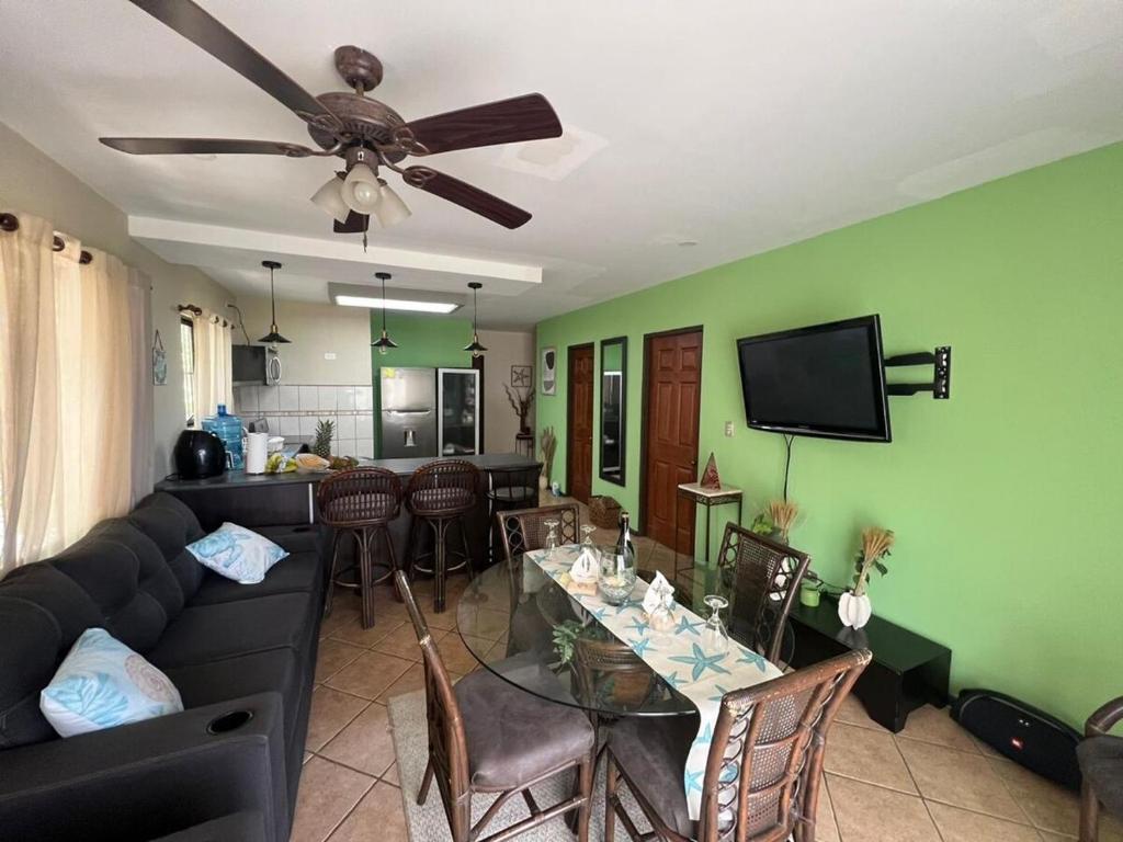 a living room with a couch and a table with chairs at Tropical Stay in Coco in Coco
