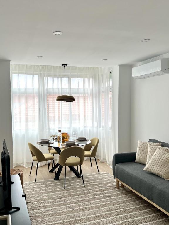a living room with a table and a couch at JC Apartments in Amadora