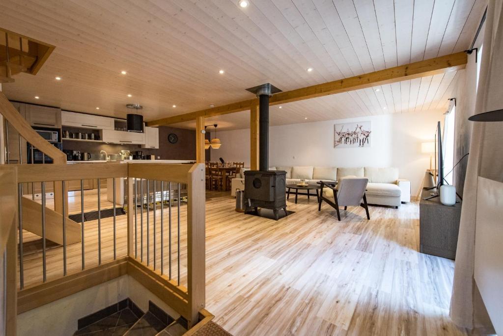 an open living room with a staircase and a living room at Renovated Triplex House 8 guests Orelle in Orelle