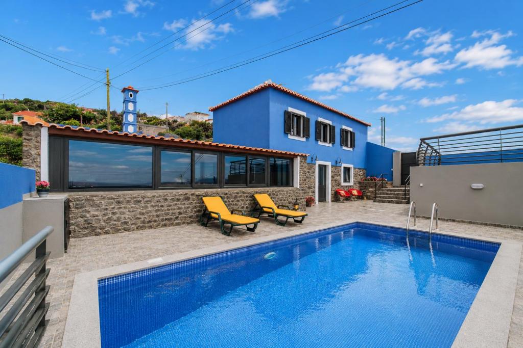 a villa with a swimming pool and a house at Casa da Morena by Amazing Madeira in Santa Cruz