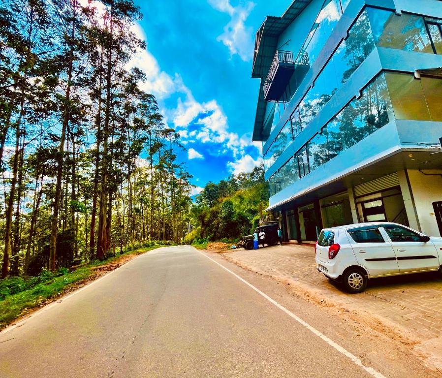 a white car parked in front of a building at Matha Residency in Kasauli