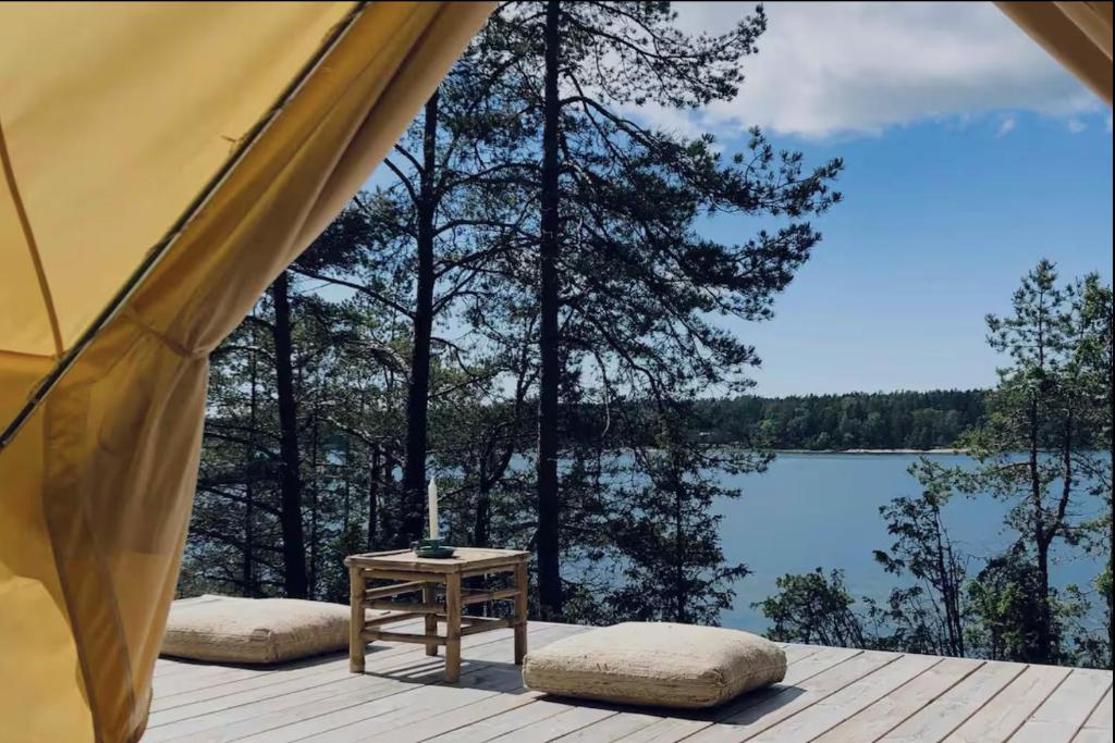 a tent with a view of a lake at Glamping - a living room overlooking the ocean in Hammarland
