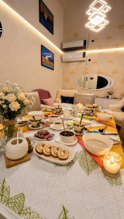 a table with plates of food on top of it at Bereka Apartment in Mtskheta in Mtskheta