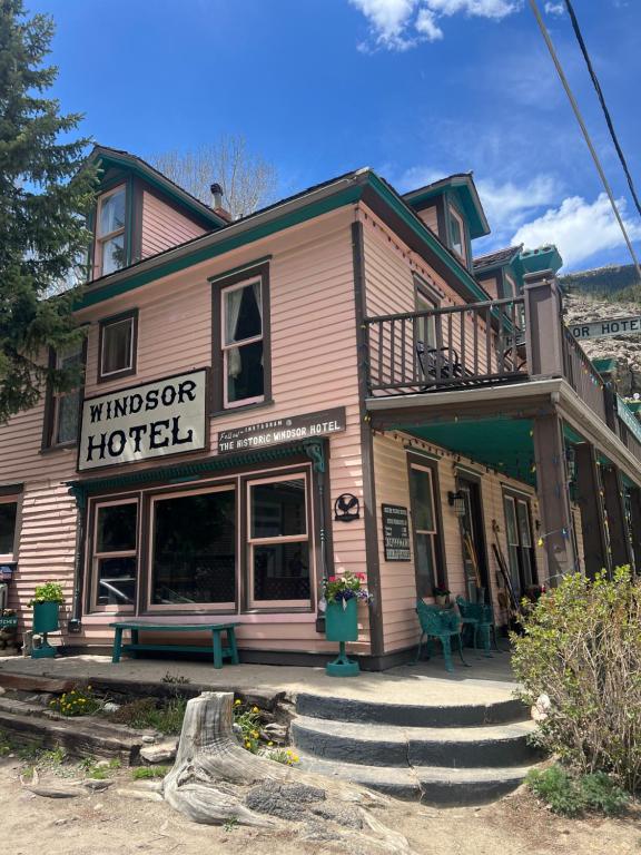 a pink building with a sign for a hotel at Historic Windsor in Silver Plume