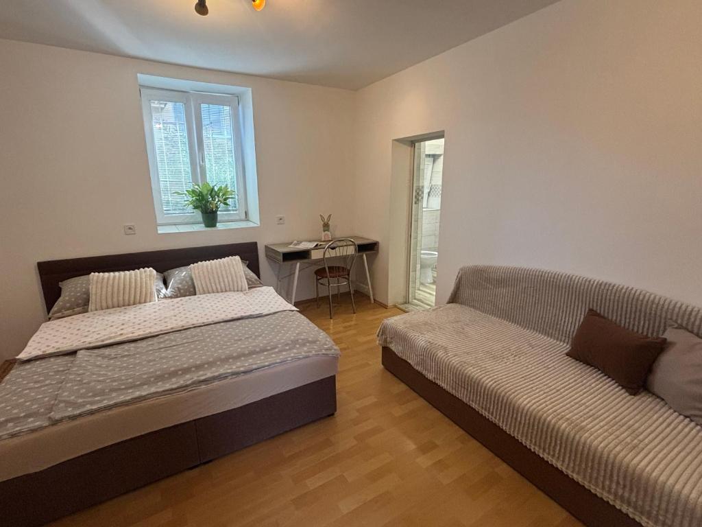 a bedroom with a bed and a couch at Grand House in Štúrovo
