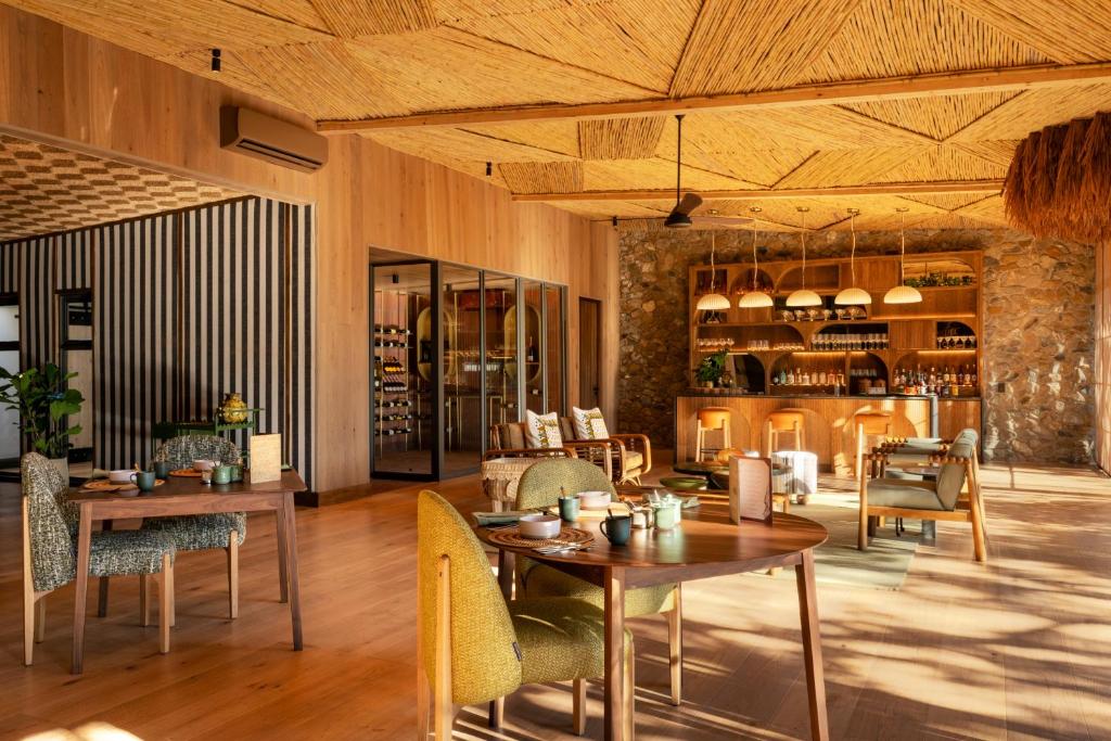 a dining room with tables and chairs and a room with at Saseka Tented Camp in Hoedspruit