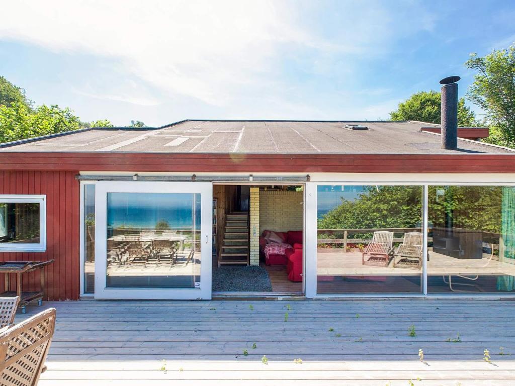 a screened in porch with a view of the ocean at 8 person holiday home in Asnæs in Asnæs