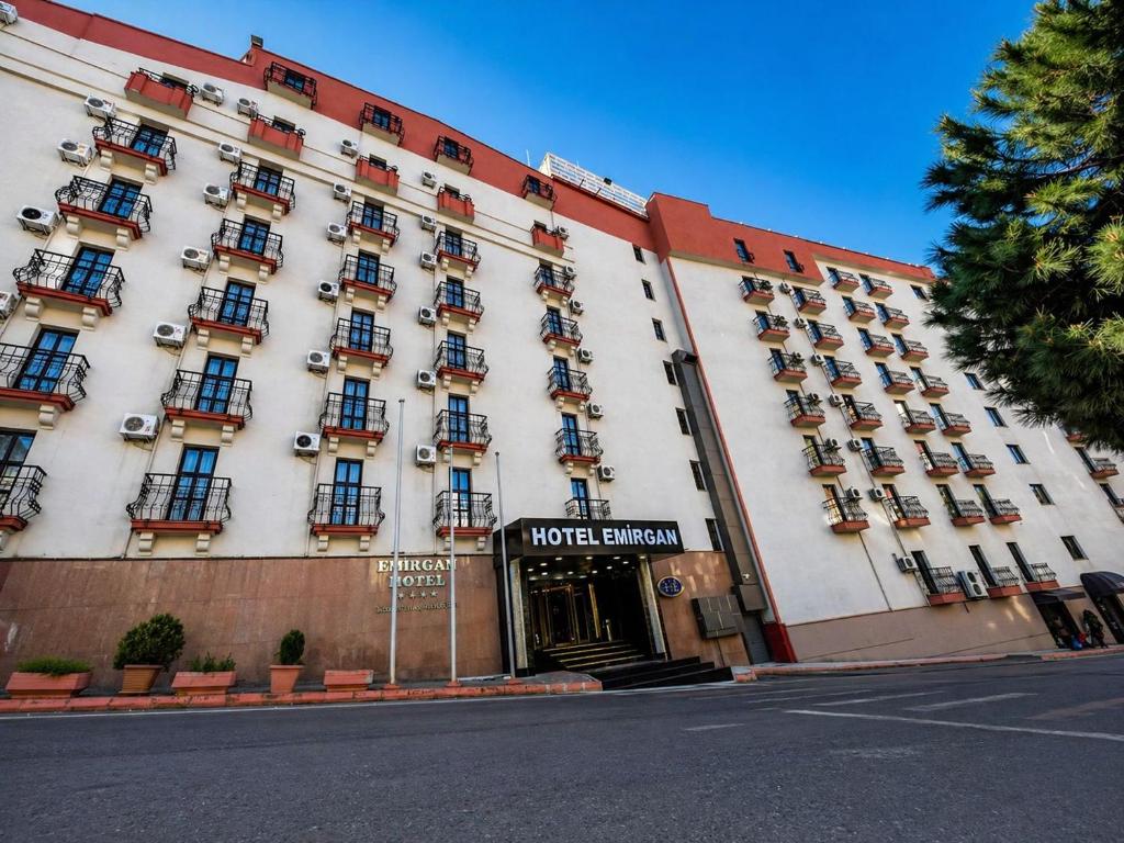 a large building with a hotel entrance on a street at EMİRGAN Otel in Bağlık