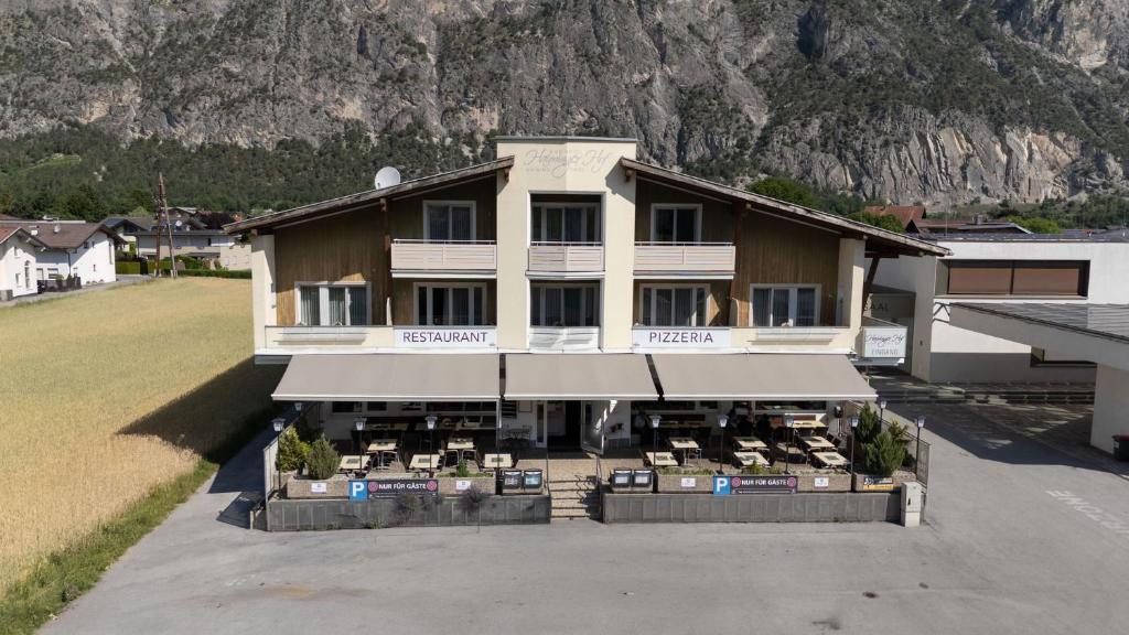 an aerial view of a building in front of a mountain at Haiminger Hof in Haiming