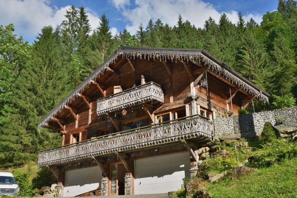 a large wooden house with a balcony on a mountain at Chalet Le Plan du Rtia in Morzine