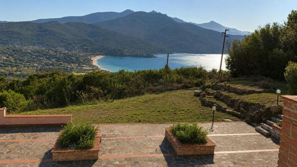a view of a body of water with mountains at Affittacamere Del Geco - Elba Affitti in Procchio