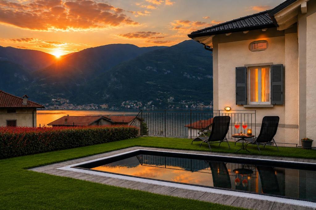 a house with a swimming pool with a sunset in the background at Lescen White Residence - Lake View in Lezzeno