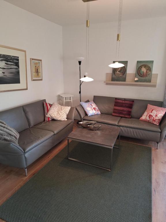 a living room with a couch and a coffee table at Ernies Gartentraum in Mattsee