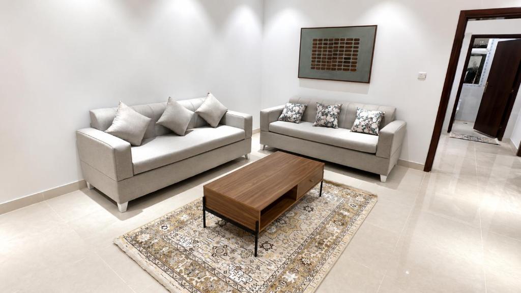 a living room with two couches and a coffee table at أرياف سويت in Al Baha