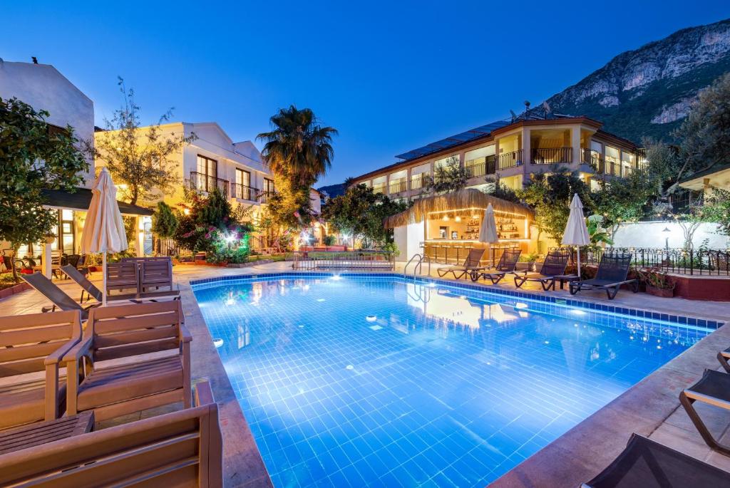 a swimming pool with chairs and a hotel at Lagoonia Sun Hotel in Fethiye