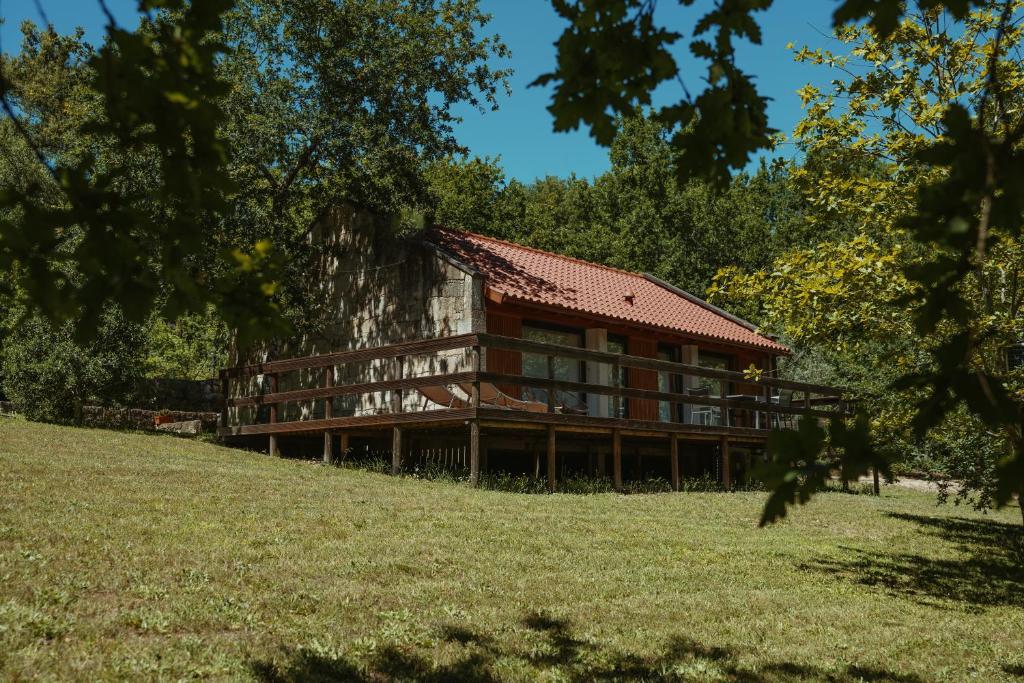 a large house on a hill with a grass field at Quinta da Fenteira - Casa Tora in Arcos de Valdevez