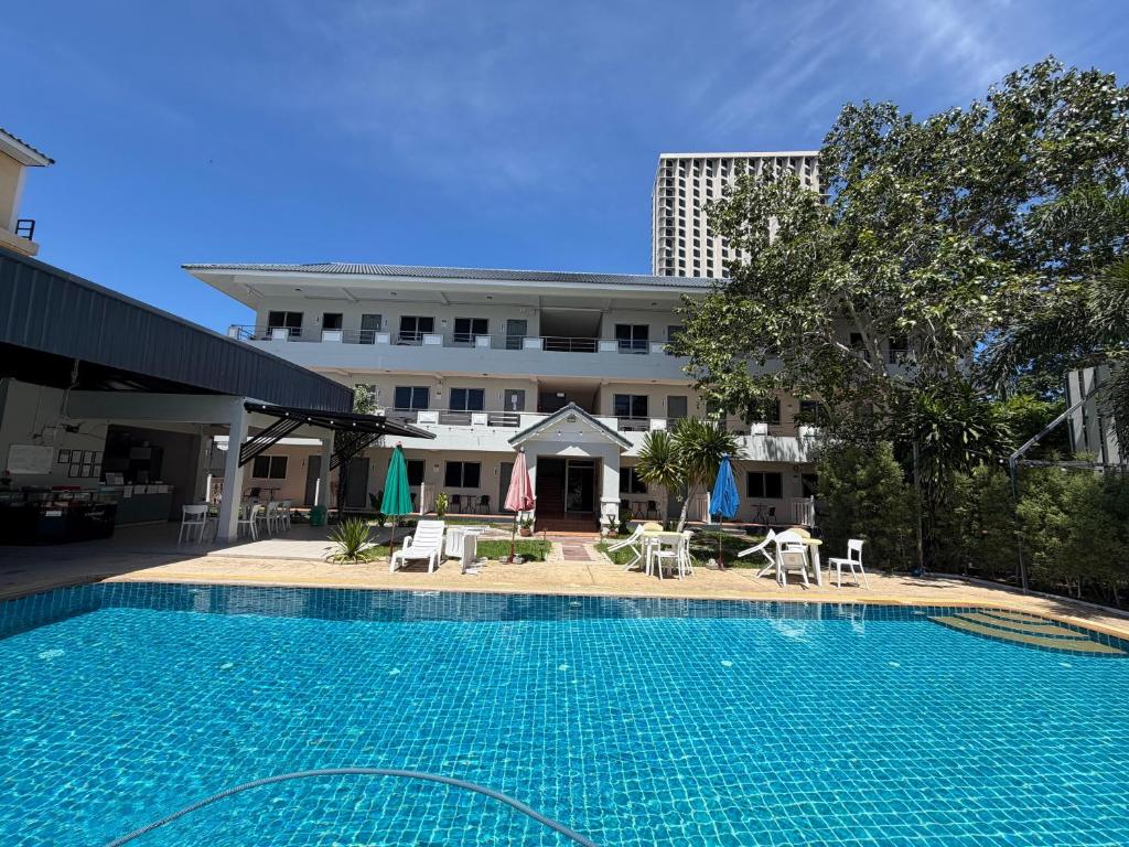 a large swimming pool in front of a building at Amaya Bloom Resort & Spa in Pattaya