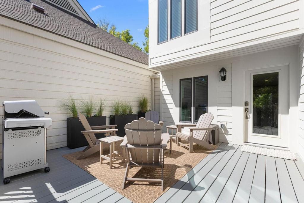 a patio with chairs and a grill on a house at 774 Spinnaker Beach House in Seabrook Island