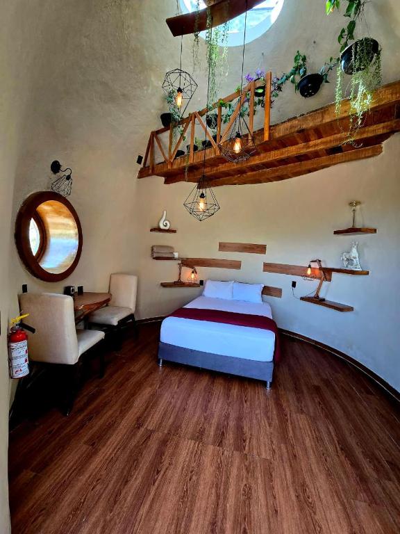 a bedroom with a bed and a desk in a room at Domo Abitare Glamping in Isla de Mezcala