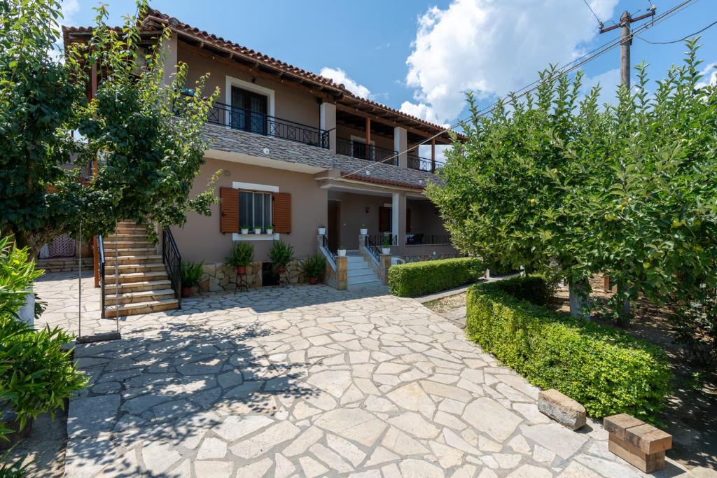 a house with a stone driveway in front of it at Villa Kevin in Berat