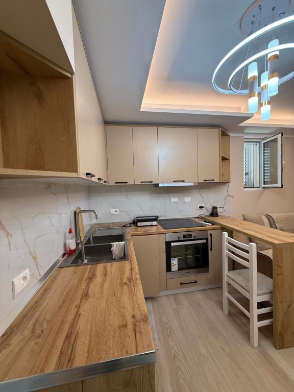a kitchen with a sink and a counter top at Alea Home in Fier