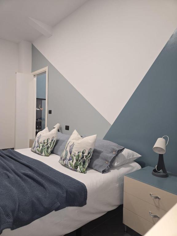 ein Schlafzimmer mit einem Bett und einer blau-weißen Wand in der Unterkunft Fico d'India in Spadafora