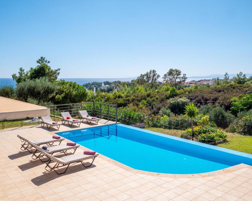 a villa with a swimming pool with a view at Villa Anna by Villa Select in Skala