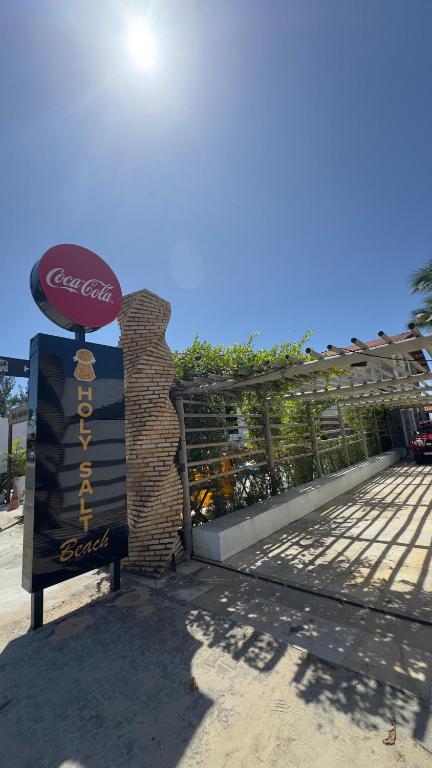 a cocacola sign in front of a fence at Pousada Holy Salt Cumbuco in Caucaia
