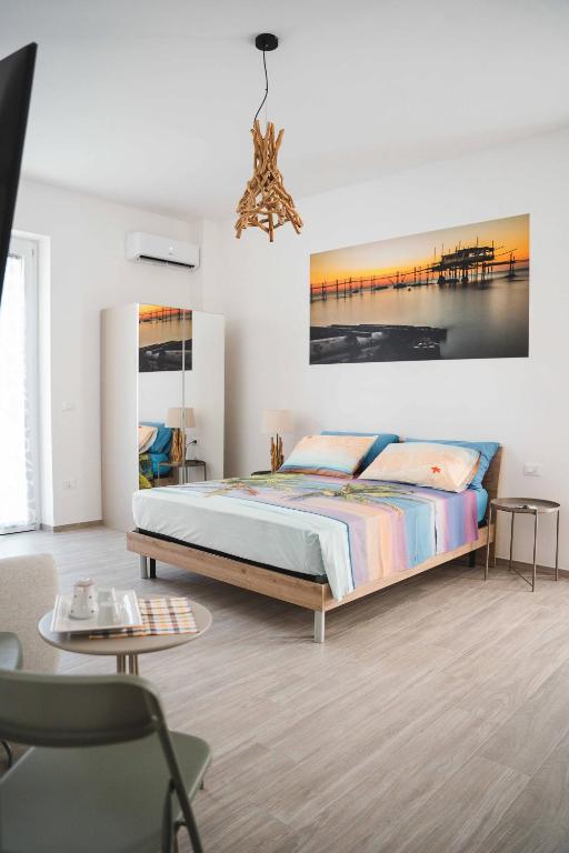 a bedroom with a bed and a painting on the wall at 3Season Ortona B&B in Ortona