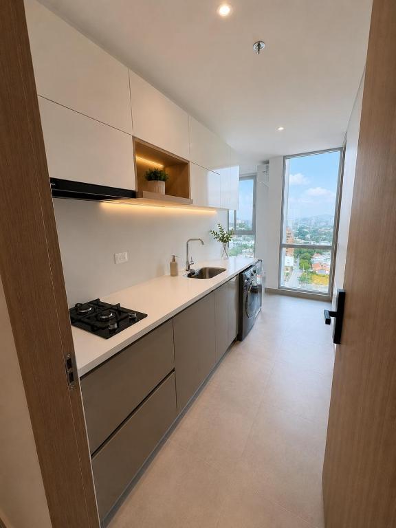 a kitchen with a sink and a stove top oven at Santamarta, marina centro historico in Santa Marta