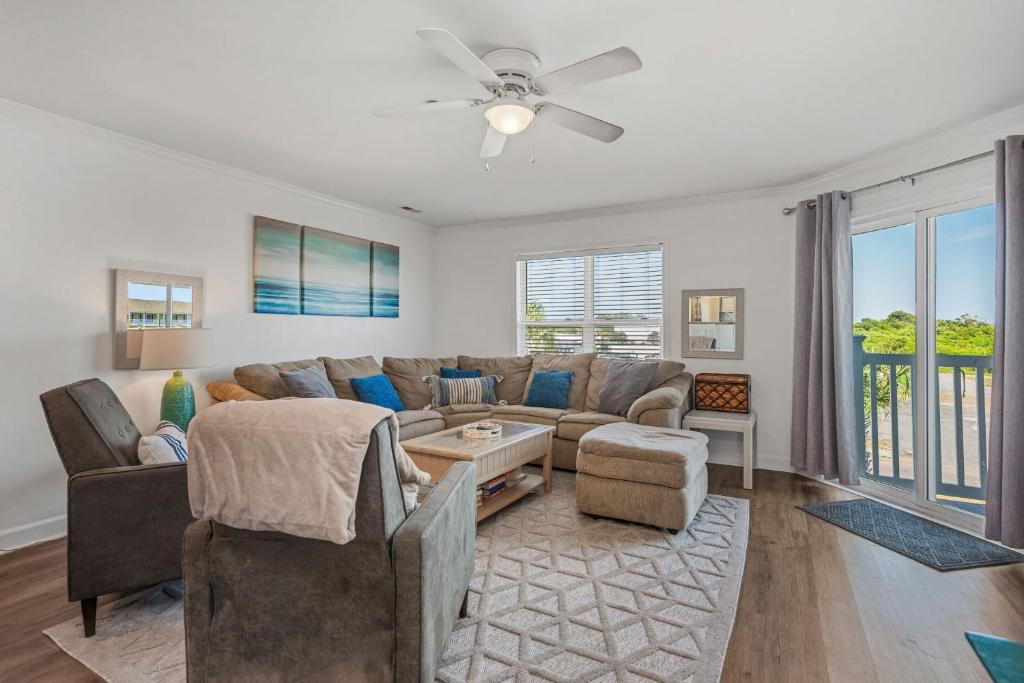 a living room with a couch and a table at Ocean Vibes by Oak Island Accommodations in Oak Island