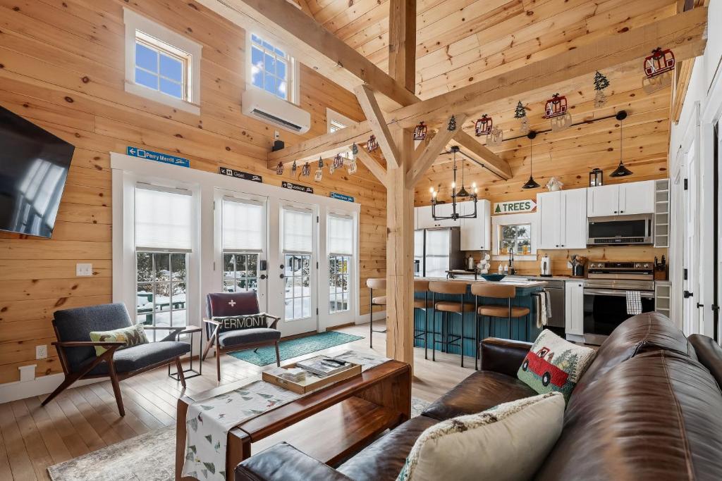 a living room and kitchen in a log home at Maple Chalet in Morrisville