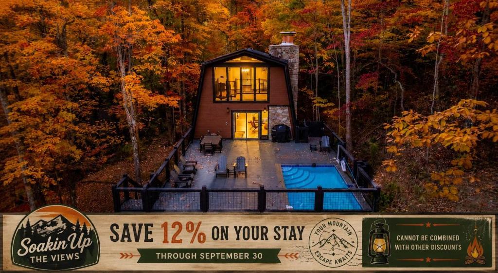 a house in the woods with a sign in front of it at Soakin Up The Views in Gatlinburg