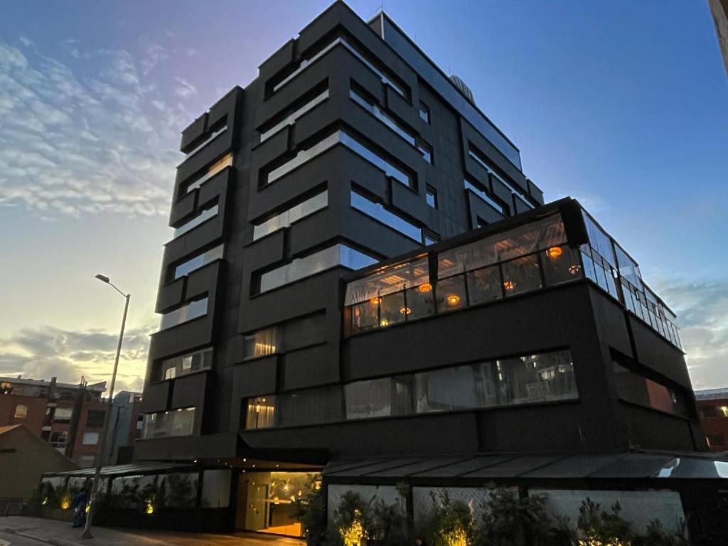 a tall black building with a lot of windows at Hotel Faranda Collection Zona G in Bogotá