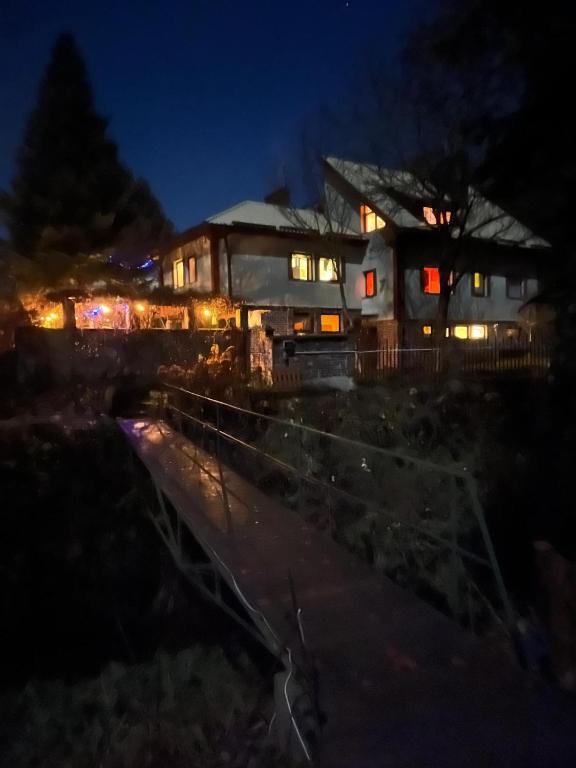a house lit up at night with lights at Siedlisko Bliss Garden Retreat House ZielonoMi in Lengenquell