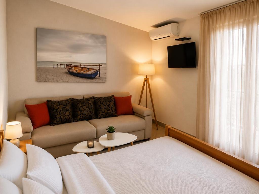 a living room with a couch and a table at Apartments Taida in Dobra Voda
